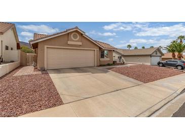 Inviting single-story home featuring a two-car garage and low-maintenance desert landscaping in the front yard at 805 Blue Springs Dr, Henderson, NV 89002