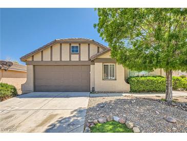 Charming single-story home featuring a two-car garage, desert landscaping, and a neatly maintained front yard at 8141 Guava Nectar Ave, Las Vegas, NV 89131