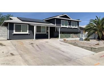 Charming home with solar panels, a spacious driveway, and a well-maintained yard at 904 Rockaway St, Las Vegas, NV 89145
