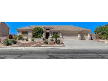 Charming single-story home with landscaped front yard and a three car garage at 931 Temple View Dr, Las Vegas, NV 89110