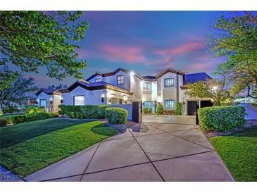 Beautiful two-story home with a manicured lawn and a circular driveway, perfect for a Gathering at 2208 Point Rock Ln, Las Vegas, NV 89134