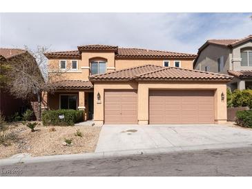 Two-story home featuring a tile roof, two-car garage, and desert landscaping at 2532 Bechamel Pl, Henderson, NV 89044
