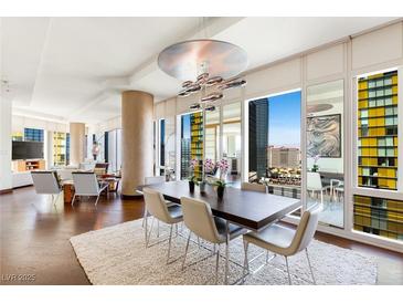 Elegant dining room with modern chandelier, a large wood table, and city views at 3750 Las Vegas Blvd # 2407, Las Vegas, NV 89158