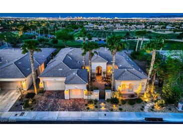 Stunning aerial view of home and landscaping, showcasing desert landscaping and golf course views with the Las Vegas strip in the background at 4564 Bersaglio St, Las Vegas, NV 89135