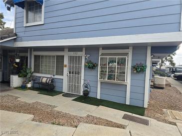 Charming exterior showcasing a well-maintained facade with outdoor seating and landscaping at 5419 Centurion Ct # 102, Las Vegas, NV 89122