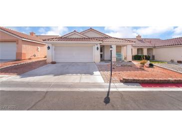 Inviting single-story home featuring a two-car garage and mature landscaping at 5532 Sentinel Bridge St, Las Vegas, NV 89130