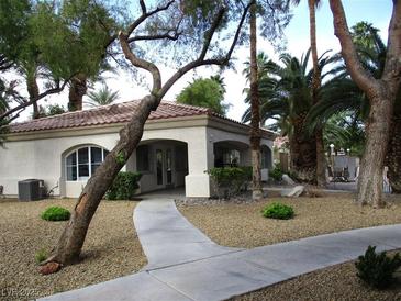 Charming single-story home with a stucco exterior and desert landscaping providing inviting curb appeal at 6480 Annie Oakley Dr # 111, Las Vegas, NV 89120