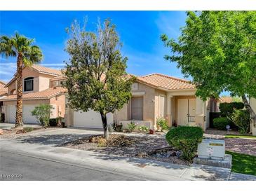 Charming single-story home featuring a well-manicured front yard, desert landscaping, and an inviting front porch at 708 Canterbury Cross Pl, Las Vegas, NV 89144