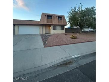Charming two-story home featuring a well-maintained front yard with mature tree and gravel accents at 7200 Alta Dr, Las Vegas, NV 89145