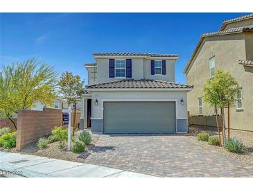 Charming two-story home featuring a paved driveway and a two-car garage at 8349 Pollenzo Ave, Las Vegas, NV 89178
