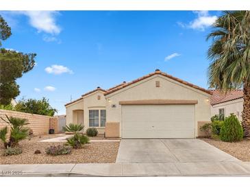 Charming single-story home showcasing a well-manicured front yard and attached two-car garage at 884 Adobe Flat Dr, Henderson, NV 89011