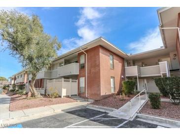 Inviting two-story exterior with landscaped yard, and ramp access for easy entry, all under a beautiful blue sky at 2866 Loveland Dr # 2017, Las Vegas, NV 89109