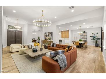 Spacious living room boasts elegant lighting, tile floors, and comfortable seating at 800 Jody Brook Ct, Las Vegas, NV 89145