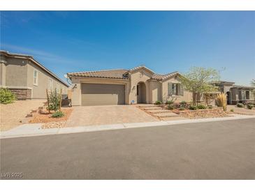 Charming single-story home with desert landscaping and a brick paved driveway at 10126 Cliff Dwellings Ave, Las Vegas, NV 89178