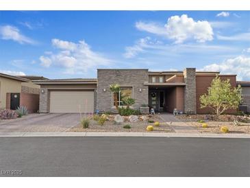 Beautiful single story home with desert landscaping, stone accents, and an attached three car garage at 10018 Regency Square Ave, Las Vegas, NV 89148