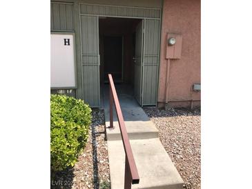 Inviting entrance with a security gate and landscaped pathway at 461 N Lamb Blvd # H, Las Vegas, NV 89110