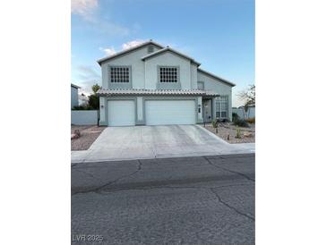 Charming two-story home with a two-car garage and a well-manicured front yard featuring desert landscaping at 7800 Four Seasons Dr, Las Vegas, NV 89129