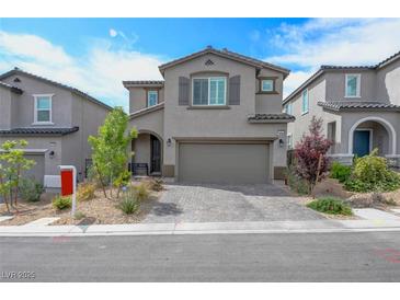 Charming two-story home featuring a two-car garage and a well-maintained, drought-tolerant front yard at 10957 Oregano Ave, Las Vegas, NV 89166