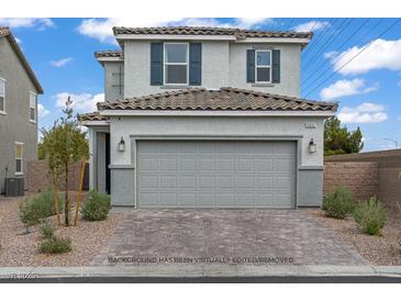 Inviting two-story home features a gray exterior, tiled roof, and two-car garage at 5692 Tinar St, Las Vegas, NV 89113
