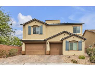 Charming two-story home featuring a three-car garage, neat landscaping, and decorative shutters at 10412 Deer Heights St, Las Vegas, NV 89178