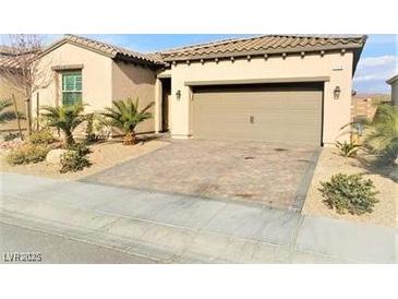 Charming single-story home featuring a two-car garage and low maintenance landscaping at 1128 Via Della Curia, Henderson, NV 89011