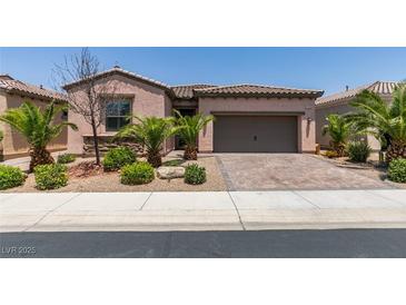 Charming single-story home featuring a two-car garage and desert landscaping at 1128 Via Della Curia, Henderson, NV 89011