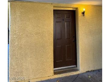 A close up of the front door with 'B' on it, with a light shining above the door at 1447 Hialeah Dr # B, Las Vegas, NV 89119