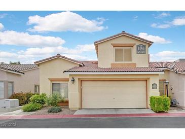 Inviting two-story townhouse features a spacious garage and well-maintained landscaping at 1453 Blisworth Ct # 102, Las Vegas, NV 89102