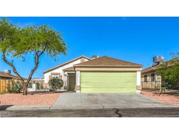 Charming single-story home featuring a well-maintained lawn and a two-car garage at 2629 Blue Reef Dr, North Las Vegas, NV 89032