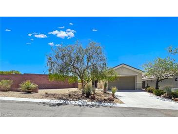 Charming single-story home with desert landscaping, mature tree, and a two-car garage at 2713 Rue Toulouse Ave, Henderson, NV 89044