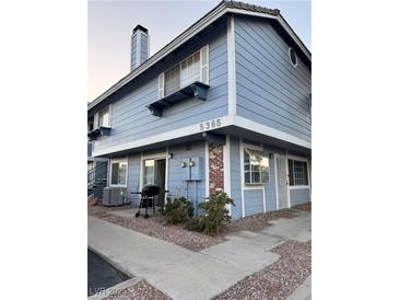 Charming two-story exterior with blue siding, brick accents and a well-maintained front yard at 5365 Shake Ct # 103, Las Vegas, NV 89122