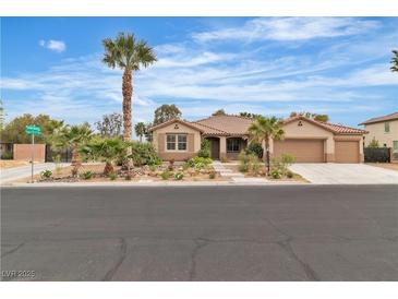Charming single-story home boasts mature landscaping, a three-car garage and a well-manicured front yard at 5889 Taylor Valley Ave, Las Vegas, NV 89131