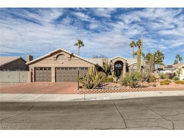 Charming single-story home with desert landscaping, a three-car garage, and beautiful curb appeal at 6308 Canyon Ridge Dr, Las Vegas, NV 89108