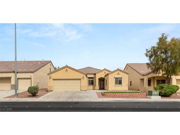 Inviting single-story home with a two-car garage and well-maintained front yard at 6512 N Bruce St, North Las Vegas, NV 89086