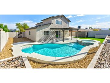 Inviting backyard pool and spa with covered patio area for relaxing and entertaining at 744 Willow Ave, Henderson, NV 89002