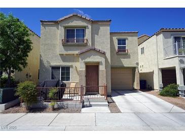 Inviting two-story home featuring a cute, fenced front porch and attached single-car garage at 7653 Fabled Filigree St, Las Vegas, NV 89149
