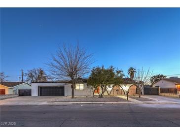 Charming single-story home featuring a well-maintained front yard and a large, attached two-car garage at 4667 E Boston Ave, Las Vegas, NV 89104