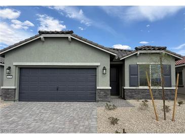 Charming single-story home featuring a two-car garage and desert landscaping at 3236 Walker River St, North Las Vegas, NV 89032