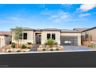 Modern single-story home with well-manicured landscaping, three car garage, and inviting entrance at 36 Thorn Creek St, Henderson, NV 89011