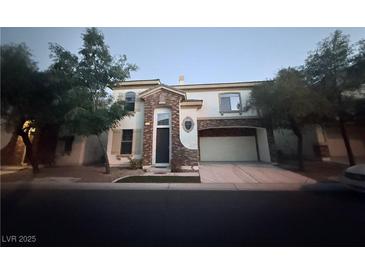 Attractive two-story home featuring stone accents, a two-car garage, and well-maintained landscaping at 141 Gryffin Ave, Las Vegas, NV 89123