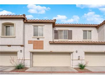 Inviting townhouse exterior with a two-car garage and desert landscaping at 1525 Spiced Wine Ave # 10102, Henderson, NV 89074
