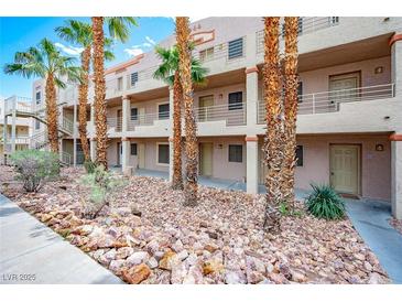 Condominium exterior featuring desert landscaping, a walkway and access to the building's entrances at 2044 Mesquite Ln # 202, Laughlin, NV 89029