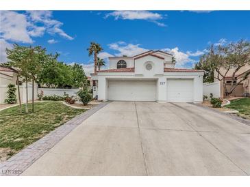 Charming two-story home with a tile roof, well-maintained landscaping, and an attached two-car garage at 227 Drysdale Cir, Henderson, NV 89074