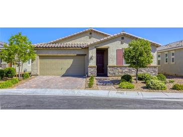 Charming single-story home with stone accents, well-manicured landscaping, and a brick driveway at 3122 Berceto Ct, Henderson, NV 89044