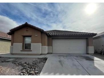 Inviting single-story home with a two-car garage and low-maintenance landscaping at 3425 Palatine Hills Ave, North Las Vegas, NV 89081