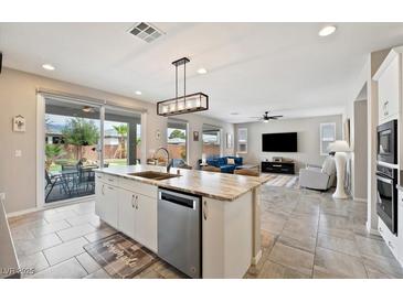 Open kitchen with a large island, stainless steel appliances, and seamless transition to outdoor living at 4531 S Bay Tree Ct, Pahrump, NV 89061