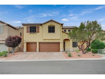 Two-story home featuring a terracotta-colored driveway and two-car garage at 7035 Chestnut Valley St, Las Vegas, NV 89166