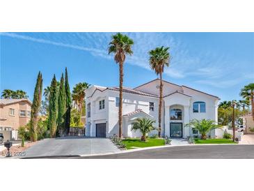 Stunning two-story home boasts lush landscaping and a pristine driveway leading to an attached garage at 8133 Desert Jewel Cir, Las Vegas, NV 89128