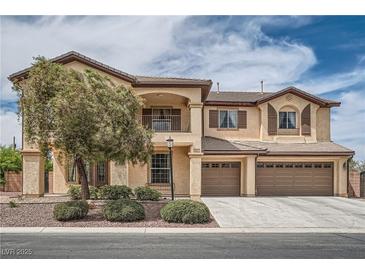 Two-story home with a three-car garage, balcony and manicured landscaping providing curb appeal at 8431 Jeremiah Grove St, Las Vegas, NV 89123
