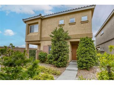 Inviting two-story home featuring well-maintained landscaping and a warm, neutral color palette at 9535 Vega Carpio Ave, Las Vegas, NV 89178